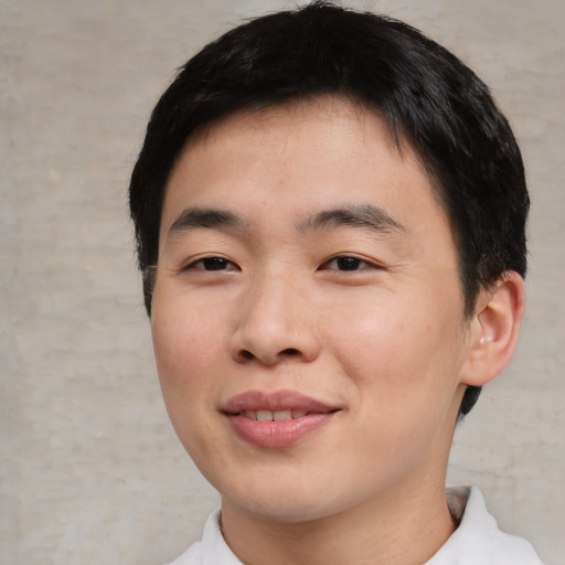 Joyful asian young-adult male with short  black hair and brown eyes