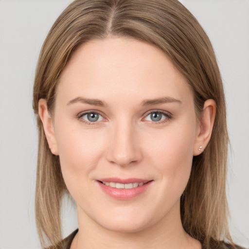 Joyful white young-adult female with long  brown hair and grey eyes