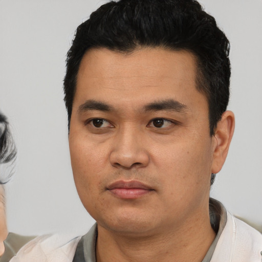 Neutral latino young-adult male with short  black hair and brown eyes
