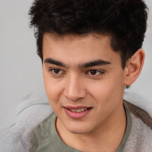 Joyful asian young-adult male with short  brown hair and brown eyes
