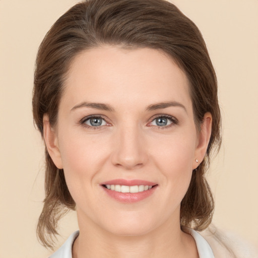 Joyful white young-adult female with medium  brown hair and brown eyes