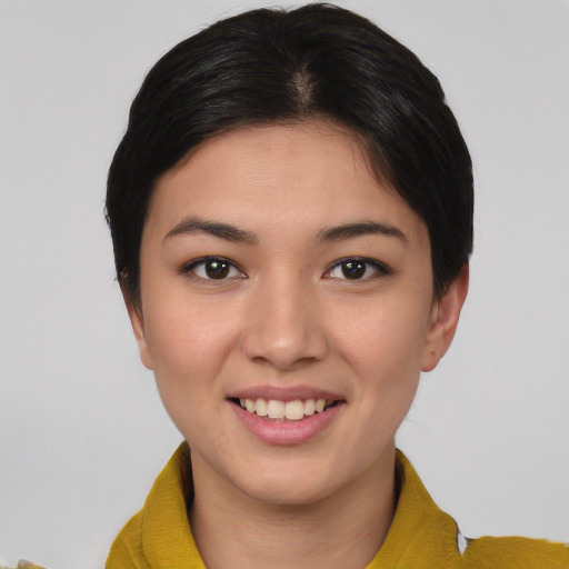 Joyful asian young-adult female with short  brown hair and brown eyes