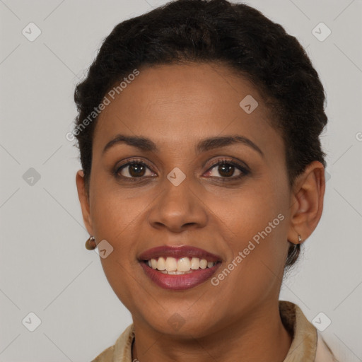 Joyful black young-adult female with short  brown hair and brown eyes