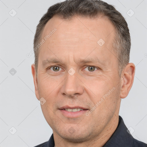 Joyful white adult male with short  brown hair and brown eyes