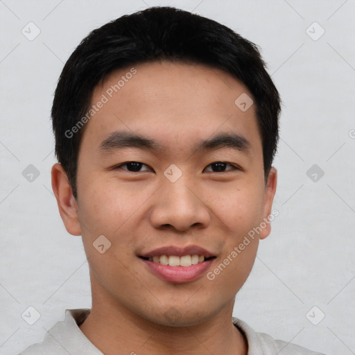 Joyful asian young-adult male with short  black hair and brown eyes