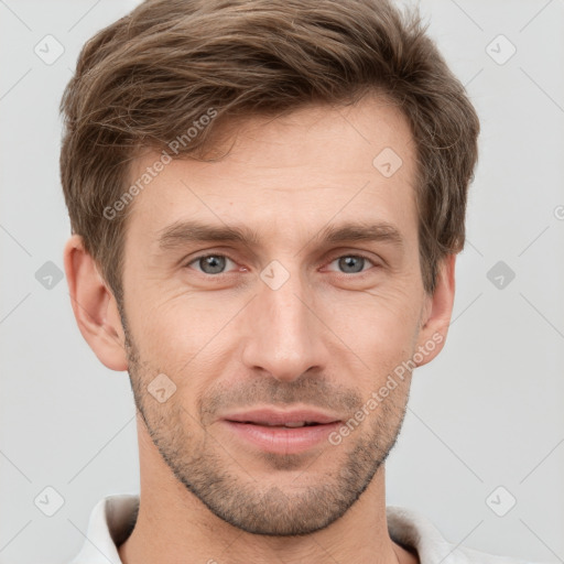 Joyful white young-adult male with short  brown hair and grey eyes