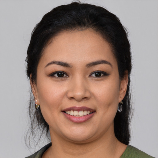 Joyful latino young-adult female with medium  black hair and brown eyes