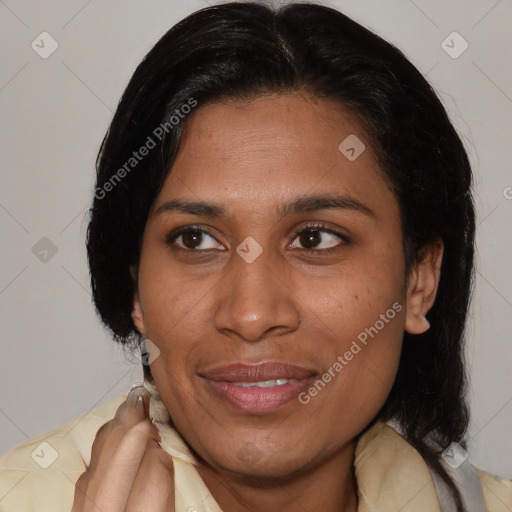 Joyful latino adult female with medium  brown hair and brown eyes