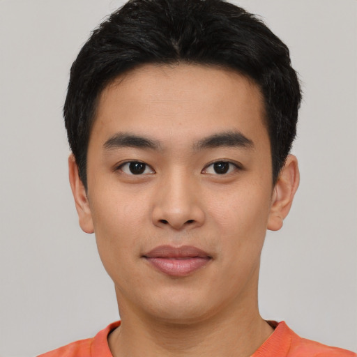 Joyful asian young-adult male with short  black hair and brown eyes