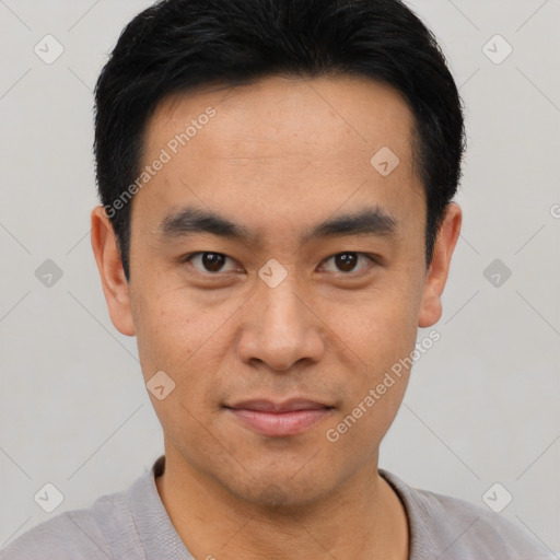 Joyful asian young-adult male with short  black hair and brown eyes