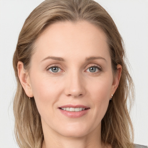 Joyful white young-adult female with long  brown hair and blue eyes