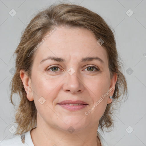 Joyful white adult female with medium  brown hair and grey eyes