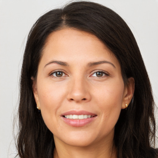 Joyful white young-adult female with long  brown hair and brown eyes