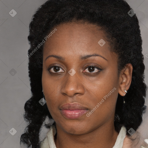 Joyful black young-adult female with long  brown hair and brown eyes