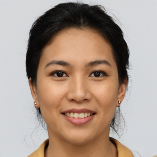 Joyful asian young-adult female with medium  black hair and brown eyes