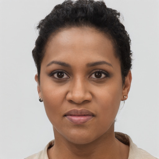 Joyful black young-adult female with short  black hair and brown eyes