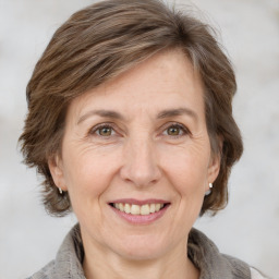 Joyful white adult female with medium  brown hair and grey eyes