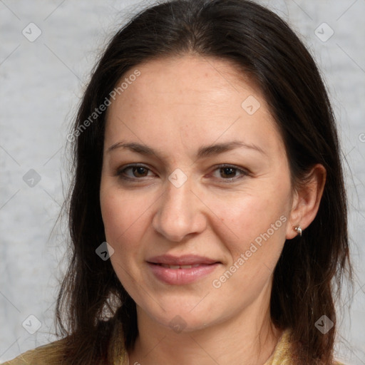 Joyful white adult female with long  brown hair and brown eyes