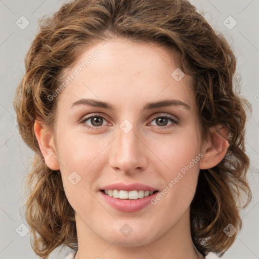 Joyful white young-adult female with medium  brown hair and green eyes