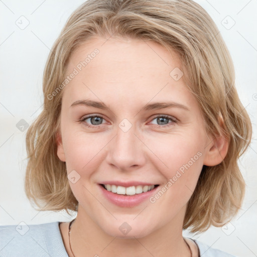 Joyful white young-adult female with medium  brown hair and blue eyes