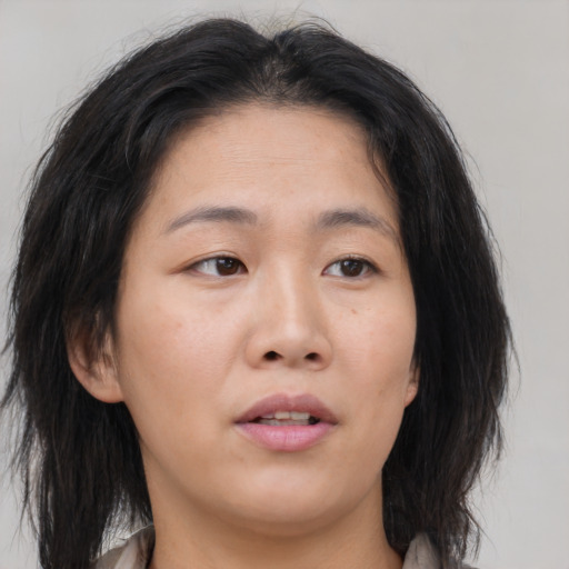 Neutral asian young-adult female with medium  brown hair and brown eyes