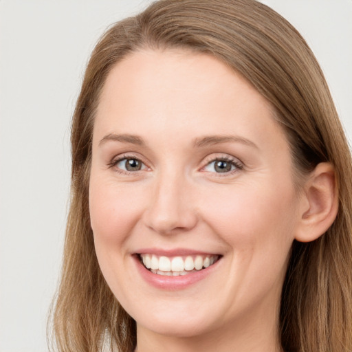 Joyful white young-adult female with long  brown hair and grey eyes