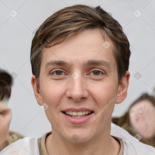 Joyful white young-adult male with short  brown hair and grey eyes