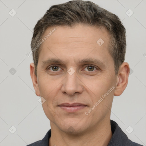 Joyful white adult male with short  brown hair and brown eyes