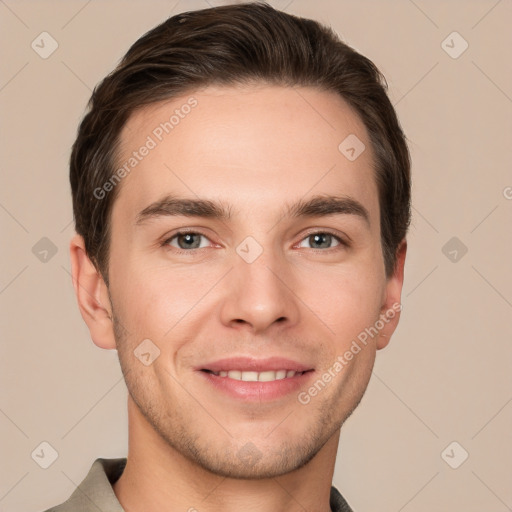 Joyful white young-adult male with short  brown hair and grey eyes