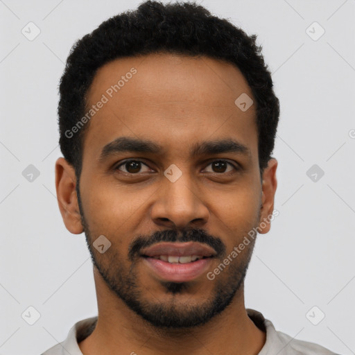 Joyful black young-adult male with short  black hair and brown eyes