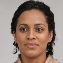 Joyful black young-adult female with medium  brown hair and brown eyes