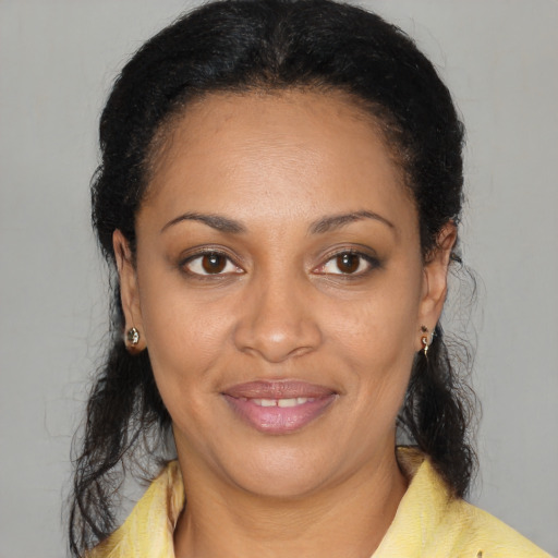 Joyful black young-adult female with medium  black hair and brown eyes