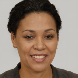 Joyful white adult female with short  brown hair and brown eyes