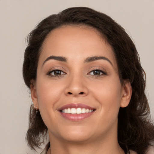 Joyful white young-adult female with medium  brown hair and brown eyes