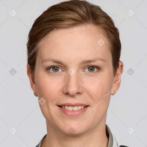 Joyful white adult female with short  brown hair and grey eyes