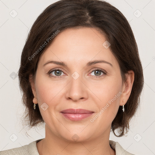 Joyful white adult female with medium  brown hair and grey eyes