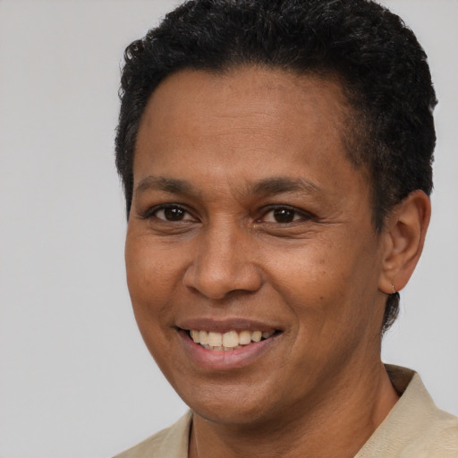 Joyful latino young-adult male with short  brown hair and brown eyes