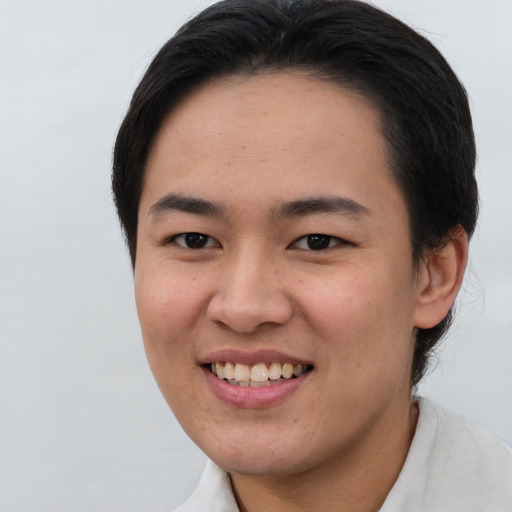 Joyful asian young-adult female with short  brown hair and brown eyes