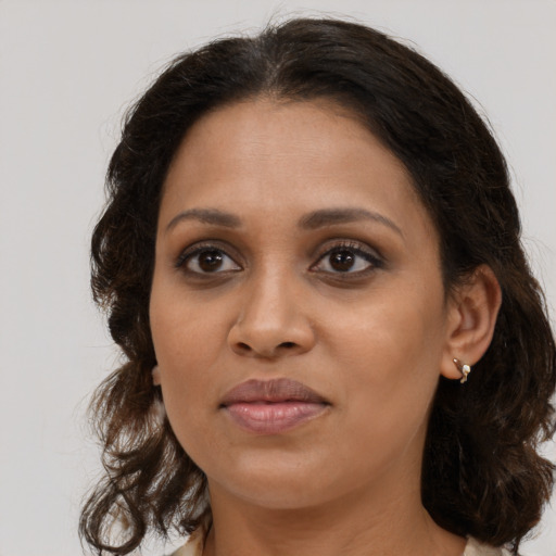 Joyful black young-adult female with medium  brown hair and brown eyes