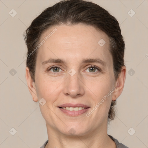 Joyful white adult female with medium  brown hair and grey eyes