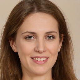 Joyful white young-adult female with long  brown hair and green eyes