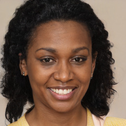 Joyful black young-adult female with medium  brown hair and brown eyes