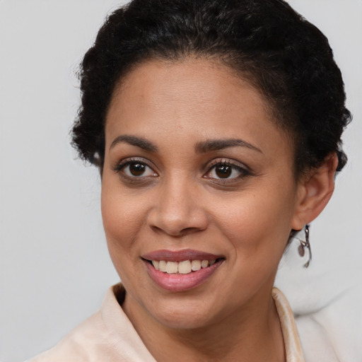 Joyful latino young-adult female with short  brown hair and brown eyes