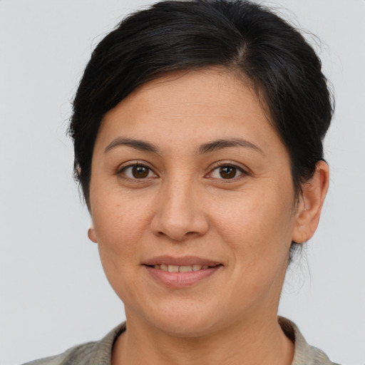 Joyful white adult female with short  brown hair and brown eyes
