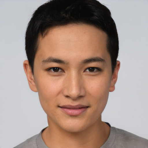 Joyful asian young-adult male with short  brown hair and brown eyes