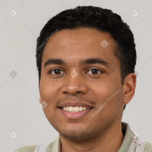 Joyful black young-adult male with short  black hair and brown eyes