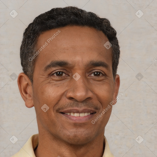 Joyful black adult male with short  brown hair and brown eyes
