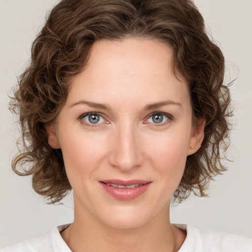 Joyful white young-adult female with medium  brown hair and green eyes