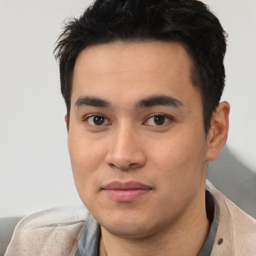 Joyful latino young-adult male with short  black hair and brown eyes