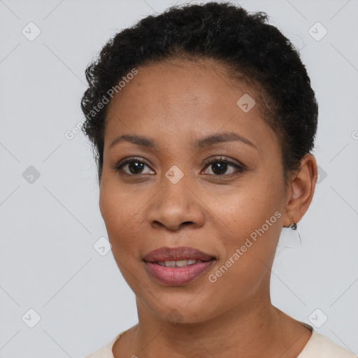 Joyful black young-adult female with short  brown hair and brown eyes